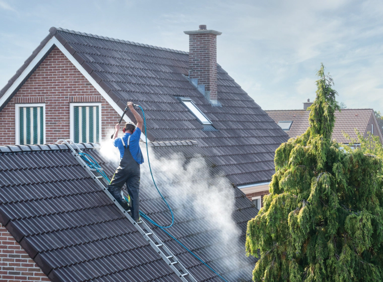 contractor power washing metal roof